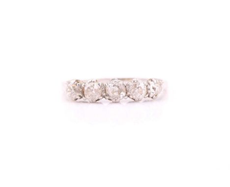 A five stone half hoop diamond ring, the slightly graduated old brilliant cut diamond in claw mounts to a plain shank. Ring s