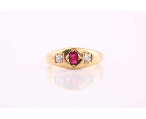 A three stone ruby and diamond ring, consisting of a central oval ruby measuring 5.0x3.2mm flanked by two transitional cut di