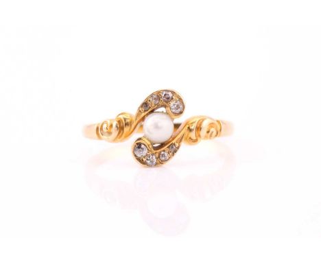 An 18ct yellow gold, diamond, and pearl crossover ring, set with a round white pearl, the stylised mount inset with diamond a