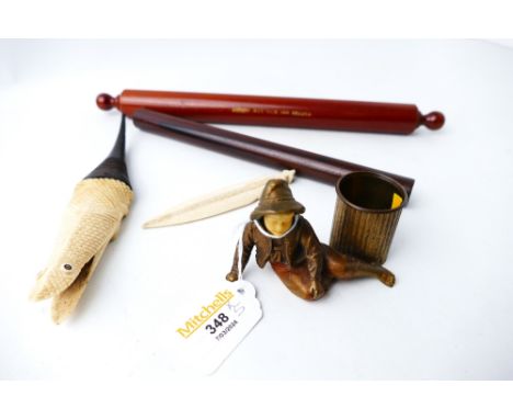 Painted cast metal and celluloid model of a boy with dustbin, carved bone and wooden model crocodile (possibly a match strike