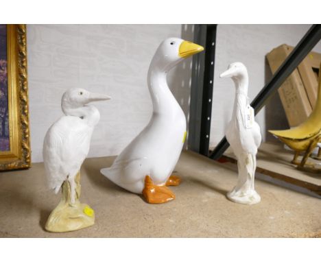 Ceramic duck and two pottery herons, marked to the base M. Norris, duck 36 cm high  