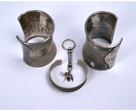 Two Indian white metal wide wrist cuffs, 7.5 cm long, 7 cm wide to/w a white metal open bangle stamped 925 and an elephant ke