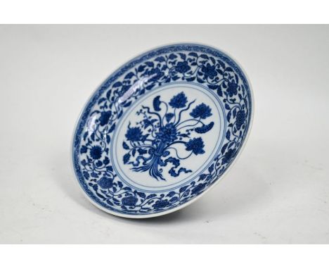 A Chinese porcelain blue and white dish, post Qing dynasty after a Ming original, the interior painted with a central bouquet