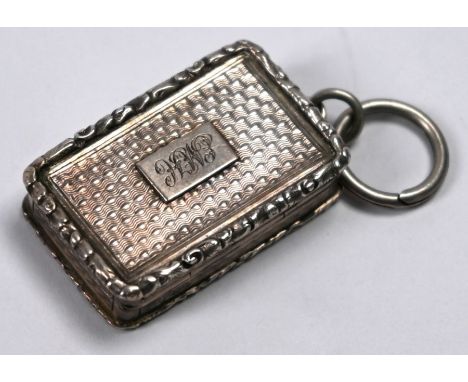An early Victorian silver fob vinaigrette with moulded rims and engine-turned engraving, the gilt lining with foliate-engrave
