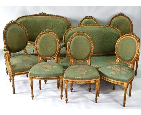 A 19th century French style carved giltwood framed salon suite, comprising a sofa, pair of armchairs and four side chairs, wi