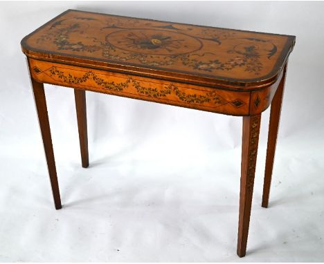 A 19th century polychrome decorated satinwood card table in the Sheraton style, the fold over baize lined top raised on twin 