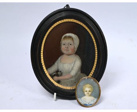 A Georgian oval portrait miniature on ivory of an infant, with blond curls in gilt brass frame 5.8 cm x 4.8 cm, to/w an oval 