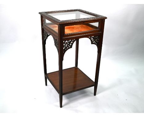 A late 19th century Chippendale revival mahogany vitrine table, with all-round glazed top over an under-tier, blind-fret deco