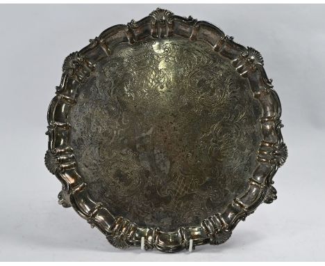 A Victorian silver salver with engraved decoration within shell, scroll and moulded border, on three scroll feet, Henry Wilki