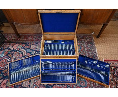 An Edwardian oak canteen with lift-out fitted trays, containing a virtually complete and extensive set of silver Hanoverian r