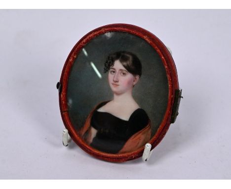 A Regency oval portrait miniature on ivory of a young lady in black gown with red shawl, unsigned, 7 x 6 cm, in red morocco-b