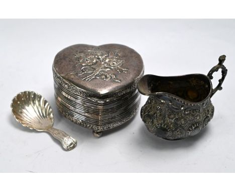 A silver heart-shaped trinket box with rose-embossed hinged cover, foliate rims and banded reeding, Chester import 1906, to/w