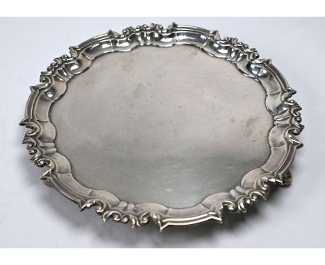 A silver salver in the Georgian manner, with moulded rim and three scroll feet, William Hutton &amp; Sons Ltd, Sheffield 1912