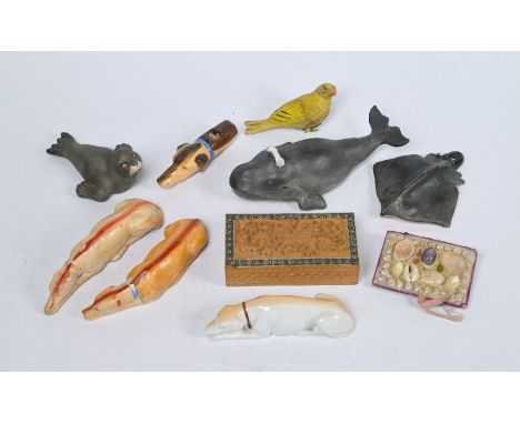 A trio of similarly modelled glazed reclining Lurchers, 11 cm long to/w a ceramic model of a whale, another of a seal, a shel