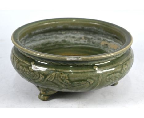 A Chinese celadon tripod censer, Ming dynasty (1368-1644) the compressed globular body incised with decorative floral and fol