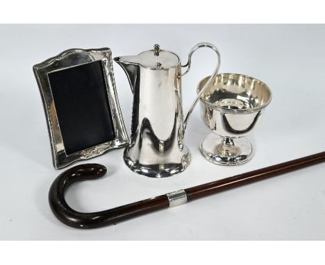 A silver-mounted easel photograph frame, to/w a silver-banded walking stick, an electroplated Art Nouveau hot water jug with 