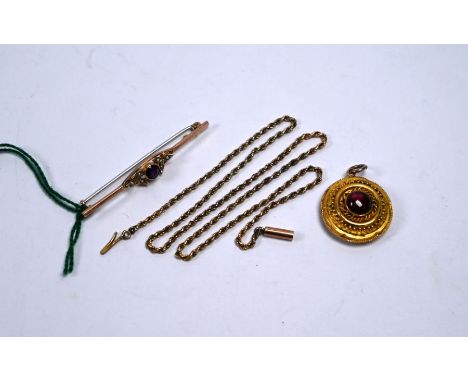 A Victorian yellow metal target style pendant with ropework decoration and central cabochon garnet with vacant locket to vers