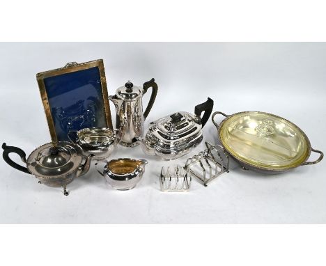 A silver cauldron-shaped teapot on hoof feet, Birmingham 1926, 10.4 oz (324g) gross and a photo frame, Birmingham 1910, 25.5 