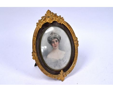 Florence Hannam (exh 1887-1906) - an oval miniature portrait of a lady, signed, 10 x 8 cm, in velvet surround and cast gilt-b