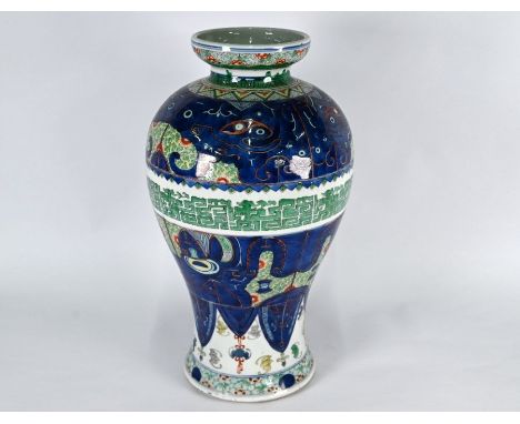 A 19th century Chinese high shouldered baluster wucai vase in the Kangxi style, painted in bright polychrome enamels with lar