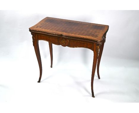 An antique Louis XVI revival brass mounted rosewood / kingwood fold-over card table, with green baize lined interior surface,