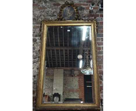 An antique gilt framed trumeau mirror, surmounted a portrait of a lady, oil, 174 cm x 93 cm&nbsp;