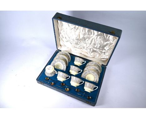 A cased set of six Royal Worcester 'Lady Evelyn' coffee cups and saucers, c/w silver gilt spoons, Sheffield 1939