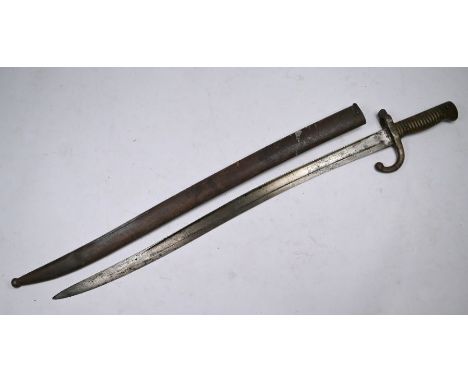 A 19th century French 1867 St Etienne bayonet with 57.5 cm fullered and recurved blade, ribbed brass hilt and steel scabbard,