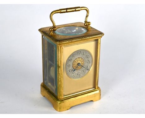 An antique brass two train 8-day carriage clock with silvered dial within a plain frosted gilt mask, striking on a coil gong,
