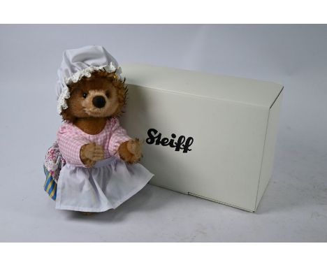 A boxed Steiff mohair 'Mrs Tiggy-Winkle', 26 cm, mint boxed with original packaging and certificate and glazed display case