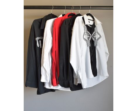 Five 1980s Versace Jeans Couture shirts, including a 100% silk black andwhite example with embroidered dragons and greco bord