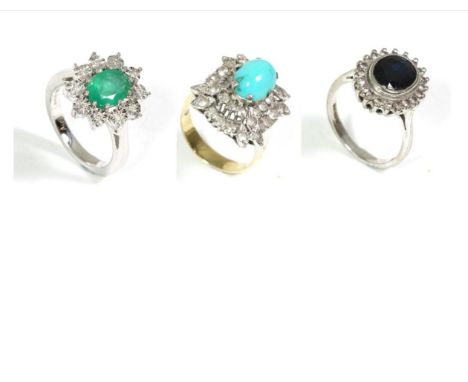 A 9 carat white gold emerald and diamond ring, an oval cut emerald in a claw setting, within a border of illusion set round b