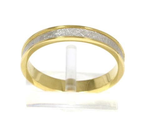 An 18 carat gold and platinum band ring, a recessed textured polished platinum band between bright polished gold bands, finge