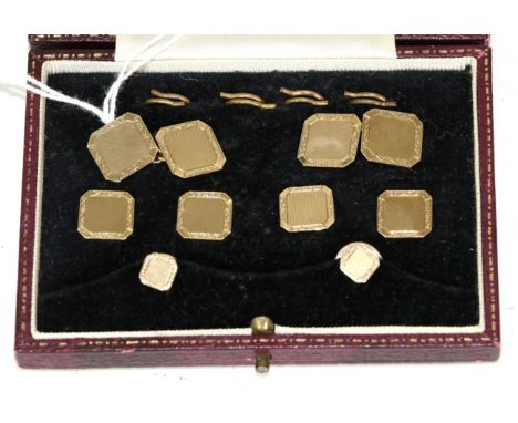 A 9 carat gold dress set, comprising; a pair of chain linked cufflinks, four buttons and two studs, of engine turned octagona