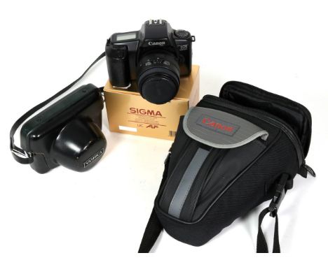 A Canon camera, two Sigma lenses (one boxed) and a Yashica camera 
