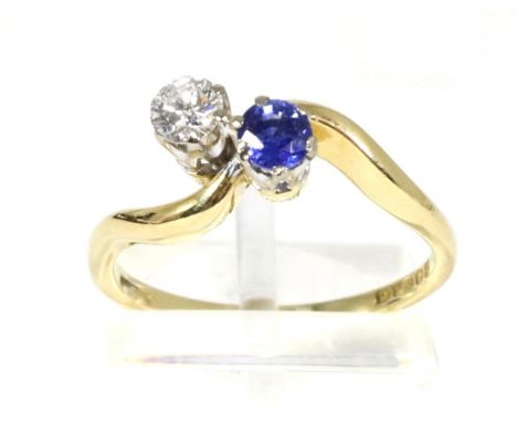 An 18 carat gold sapphire and diamond two stone ring, a round cut sapphire and a round brilliant cut diamond in claw settings