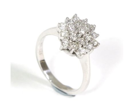 A diamond cluster ring, of three tiers of round brilliant cut diamonds in claw settings, to knife edge shoulders, total estim