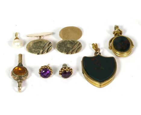 A bloodstone shield-shaped locket locket pendant, with chased decoration to the reverse, measures 3cm by 2.5cm; a bloodstone 