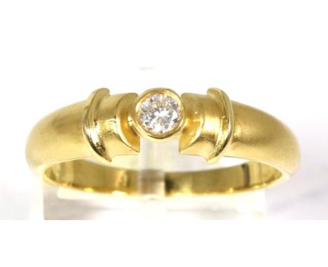 An 18 carat gold solitaire diamond ring, a round brilliant cut diamond in a rubbed over setting, to brushed polished angular 