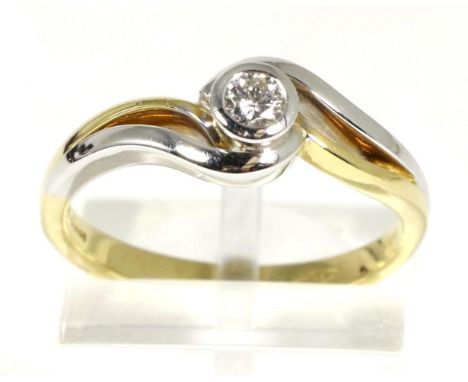 An 18 carat two colour gold solitaire diamond ring, a round brilliant cut diamond in a rubbed over setting, to white and yell