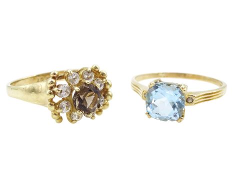 Gold three stone blue topaz ring and a gold smokey quartz and cubic zirconia cluster ring, both 9ctCondition Report:Approx 6.