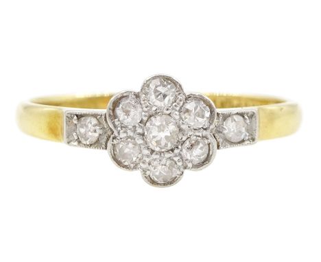 Early 20th century gold milgrain set, old cut diamond daisy cluster ring, with a single diamond set either side, stamped 18ct