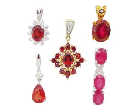 Three white gold pendants including ruby and diamond, fire opal and diamond and garnet and white topaz and two yellow gold pe