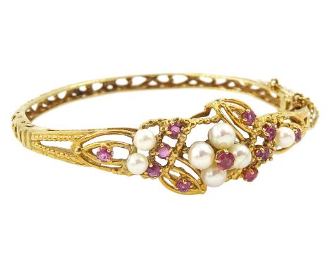 9ct gold pearl and ruby bangle pierced flower design hinged bangle, London 1985Condition Report:Approx 14.6gm, inner circumfe