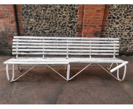 A painted wood and wrought iron slatted garden bench, 87 cm high x 243 cm wideLocation: 
