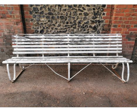 A painted wood and wrought iron slatted garden bench, 87 cm high x 243 cm wideLocation: 