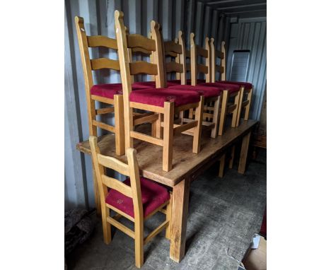 A large pine rectangular topped dining table, 83cm h x 212cm w together with ten ladder back chairsLocation: 