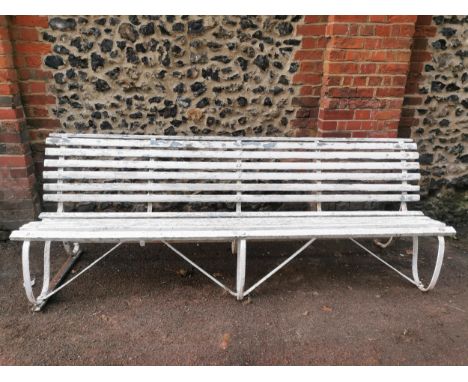 A painted wood and wrought iron slatted garden bench, 87 cm high x 243 cm wideLocation: 