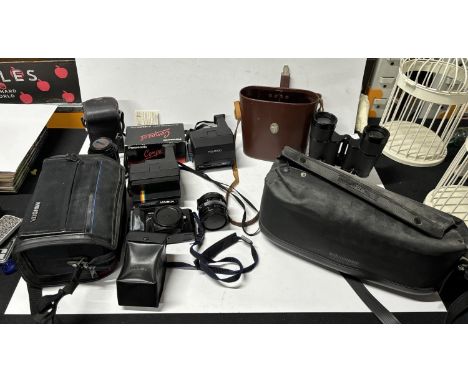 Collection of cameras including binoculars and Minolta camera with Polaroid 