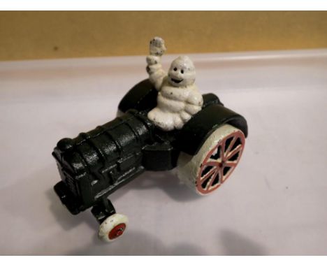 Cast iron Michelin man on a tractor, H: 80 mm. P&amp;P Group 1 (£16+VAT for the first lot and £2+VAT for subsequent lots) 